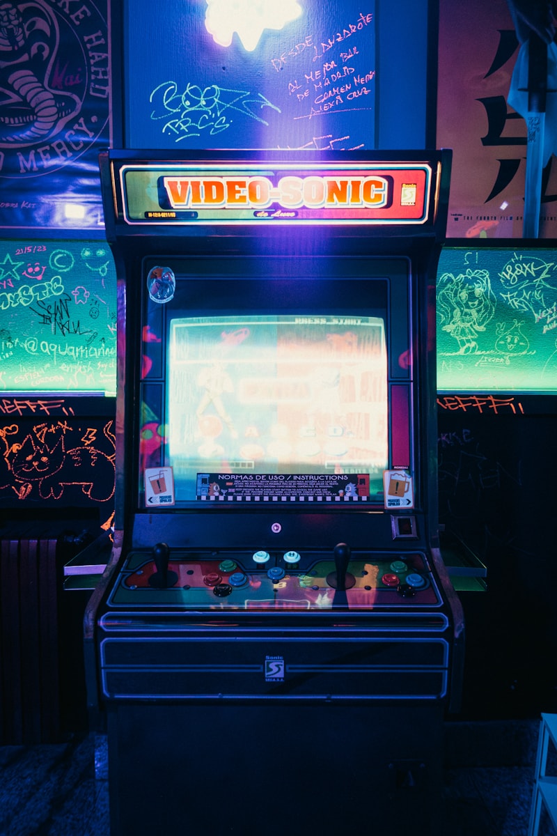Vintage neon arcade machine glowing in darkness — the classic arcade atmosphere